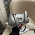 Chic silver metallic underarm bag with a silver bow buckle for a stylish summer look - Silver