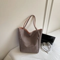 Brown and black checkered tote bag with pink lining shown in a modern lifestyle setting - Coffee
