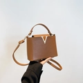 Brown textured leather handbag with gold V-metal buckle and adjustable shoulder strap - Brown
