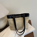 Chic beige straw tote bag with black leather trim and shoulder strap in a minimalist style - Black