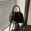 Sac à main coquillage en cuir verni noir brillant avec détails dorés et bandoulière - Noir