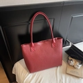 Detail of red woven texture on a large capacity tote bag with laptop for commuting - Burgundy