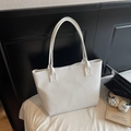 Close-up of a white tote bag featuring large capacity and premium woven texture surface - Off White