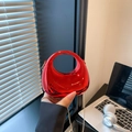 Vibrant red mirror finish acrylic dumpling bag with glossy crescent shape and chain - Red