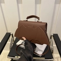 Minimalist brown matte leather tote bag with unique bat design and adjustable shoulder strap - Brown