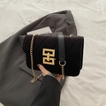 Elegant black velvet crossbody bag with a gold geometric clasp and metal chain strap - Black