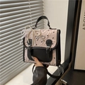 Roze en zwarte crossbodytas met strikprint, parelhanger en lederen handvat - Met Hanger / Roze