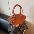 Brown shell-shaped handbag with decorative knot tassel and adjustable shoulder strap - Brown