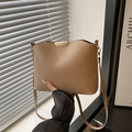 Minimalist beige crossbody bag with gold metallic trim and a sleek leather finish - Khaki