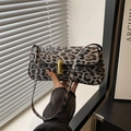 Elegant leopard print baguette bag with golden U-shaped buckle and long shoulder strap - Black