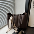 Bolso tote grande de cuero marrón oscuro con costuras blancas y correa de moda en alféizar - Marrón