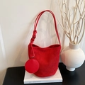Minimalist red matte bucket shoulder bag with matching round pouch on books - Red