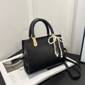 Elegant black crossbody bag with pearl bow pendant and textured finish for women - With Pendant / Black