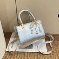 Silver metallic small square handbag with pearl bow charm and crossbody strap - With Pendant / Silver