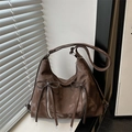 Brown nylon hobo bag featuring decorative bow zippers and adjustable shoulder strap - Brown