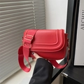 Minimalist red saddle bag with three curved seams and a wide nylon shoulder strap - Red