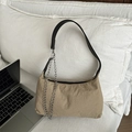 Khaki canvas hobo bag with black leather strap and silver chain detail on white pillow - Khaki