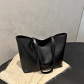 Minimalist black faux leather tote bag with gold lettering and slim shoulder straps - Black