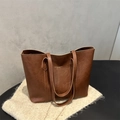 Minimalist brown leather tote bag with gold lettering logo for stylish daily commute - Tan