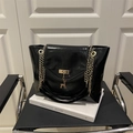 Glossy black leather tote bag featuring a gold chain strap and deer charm pendant - Black