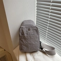 Gray nylon crossbody chest bag with pleated texture and round metallic M logo emblem - Gray