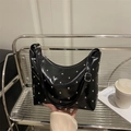 Retro black bucket bag with silver studs on a metal chair, chic fashion style - Black