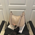 Beige faux leather half-moon shoulder bag with wide strap and silver buckle detail - Khaki
