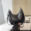 Chic black crescent crossbody bag with smooth leather finish and thin shoulder strap - Black