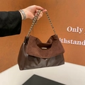 Dark brown leather and suede crossbody bag with gold chain strap in hand - Brown