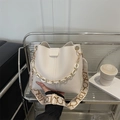 Chic beige lychee leather bucket bag with resin chain handle and wide woven strap - White