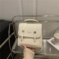 Minimalist creamy beige textured leather backpack with gold metal accents for women - White