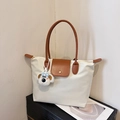 Chic cream tote bag with brown leather handles and cute white puppy plush charm - With Pendant / White