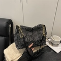 Retro black tweed shoulder bag with golden chain strap in a cozy interior setting - Black Tweed Shoulder Bag / Black