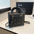 Classic black square crossbody bag with embossed logo and golden metal rings - Black