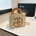 Beige and brown crossbody bag with BB logo and leather handles on white surface - Khaki