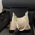 Minimalist beige dumpling bag in half-moon shape with gold hardware in gift box - White