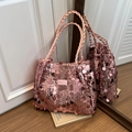 Pink sequin tote bag with woven handles and fashion label in a stylish interior setting - Pink