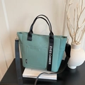 Mint green canvas bento tote bag with adjustable shoulder strap and large front pocket - Green