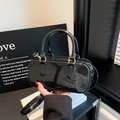 Glossy black patent leather bucket bag with gold hardware and stylish double handles - Black