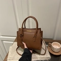 Brown faux crocodile leather handbag with adjustable strap in an autumn setting - Dark Brown