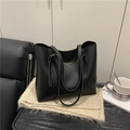 Minimalist black tote bag in matte synthetic leather with golden hardware accents - Black