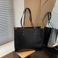 Classic black faux leather tote bag with stylish gold rivets and shoulder straps - Black
