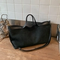 Retro black suede tote bag with leather handles on a rustic wood surface for women - Black