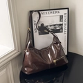 Dark coffee glossy leather dumpling bag with gold hardware and stylish side pocket - Brown