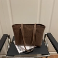 Dark brown suede tote bag with leopard print design for women on a stylish chair - Brown