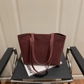 Large burgundy leopard print tote bag in matte leather texture on a magazine - Red