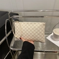 Chic cream rectangle clutch with brown M pattern and a sleek wristlet strap - Rick Morty McDonald White