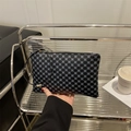 Chic black and blue geometric patterned clutch bag with a slim wrist strap and zipper - Clover - Black