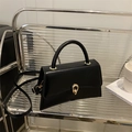 Minimalist black faux leather crossbody bag with golden metal buckle and top handle - Black