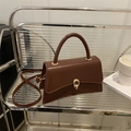 Minimalist deep brown crossbody square bag featuring a gold ring buckle and top handle - Brown